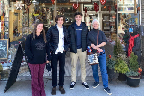 Four people standing in front of a store